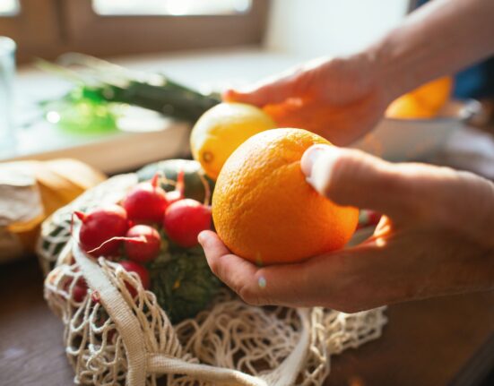 senior man unpacking groceries at kitchen reusable royalty free image 1740377180.pjpeg