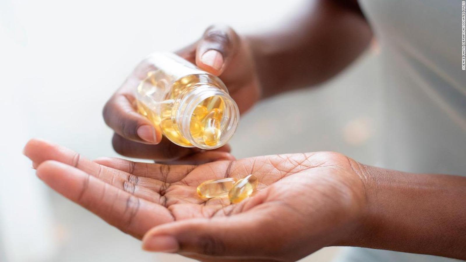 cnne 1234350 woman pouring capsules into her hand